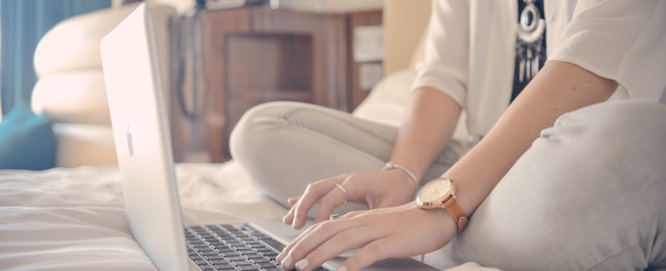 woman writing on a laptop